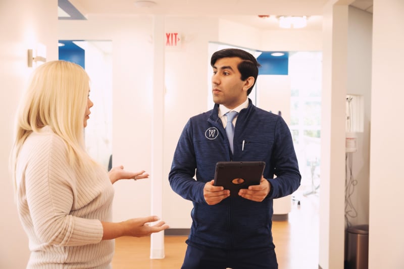 Dentist at Opal Dental Group showing around a patient