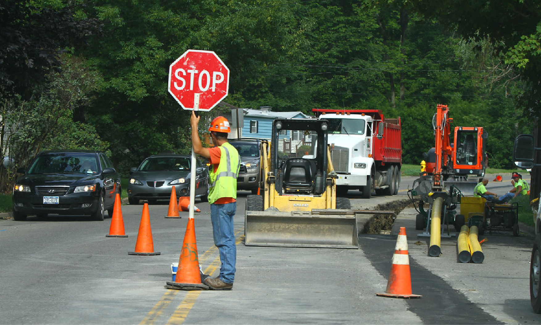 A road worker at a road construction site, emphasizing work requirements