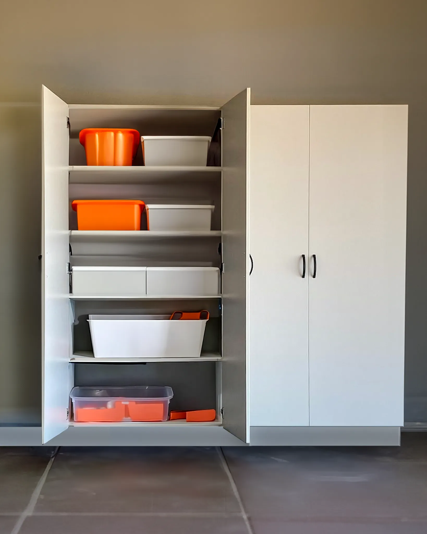 White cabinet with multiple shelves holding orange and white storage bins and containers, with one set of doors open.