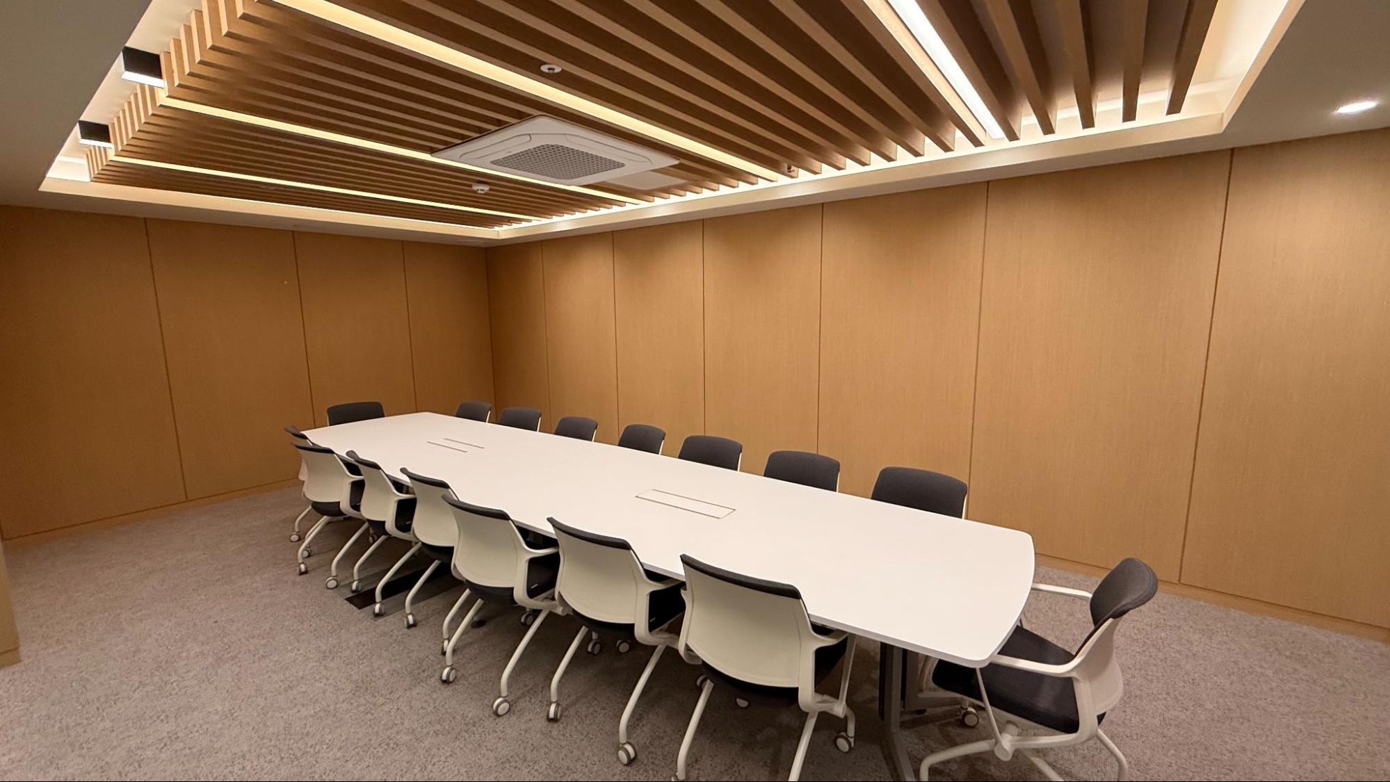 Group of diverse women posing cheerfully on yoga mats outdoors with city skyline in the background.