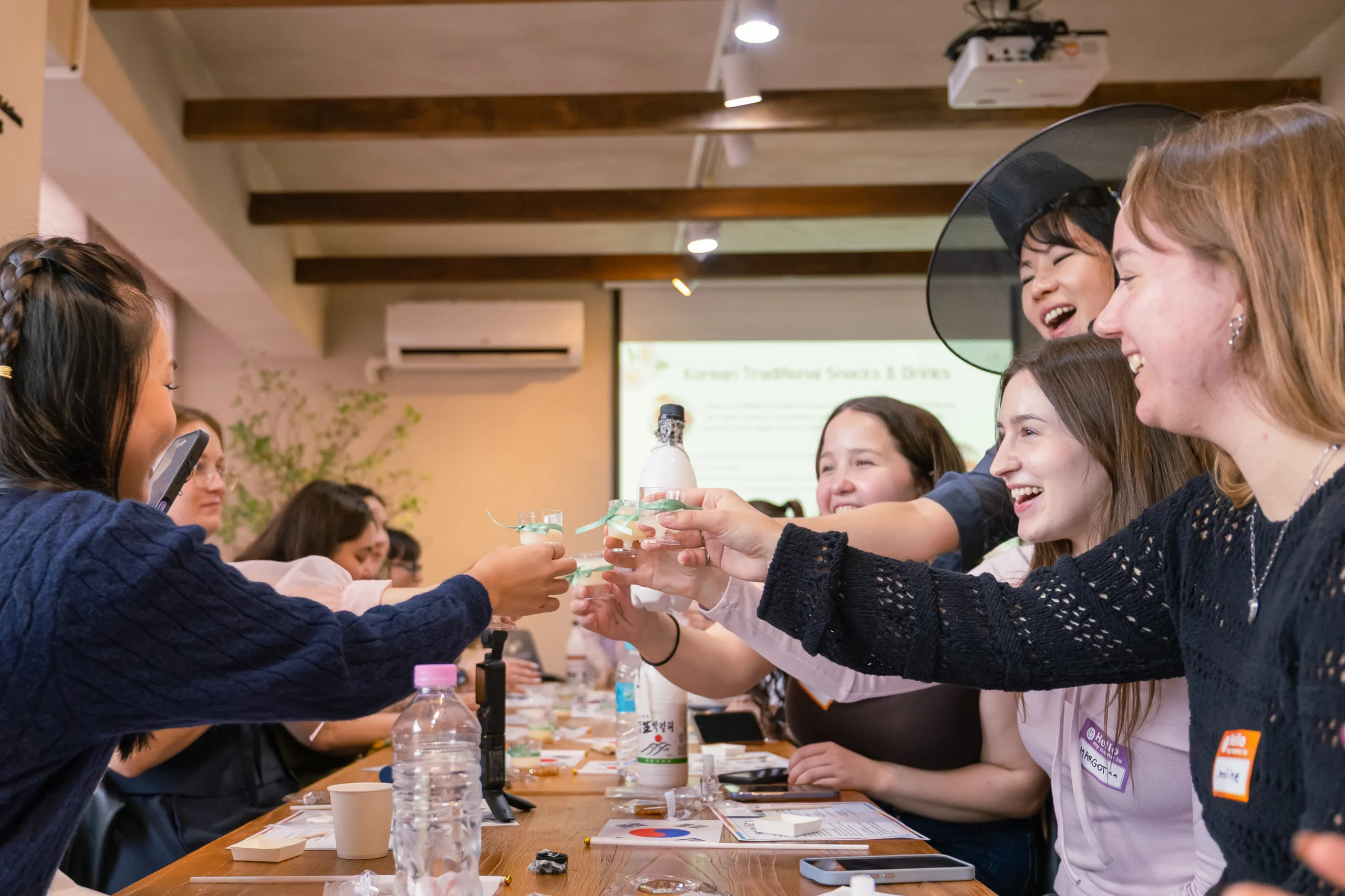 A host welcoming her group of women travelers