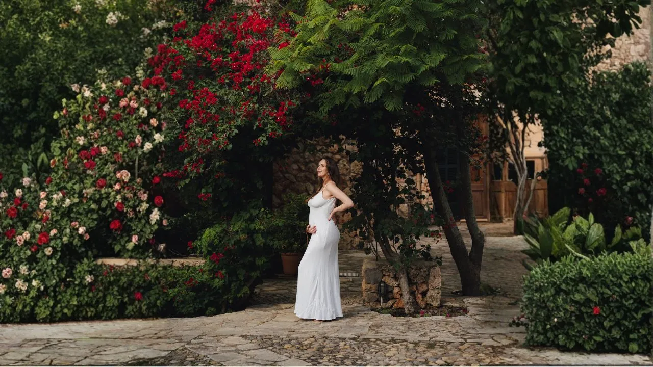 Pregnant woman in a Mediterranean courtyard garden at a mom'z retreat