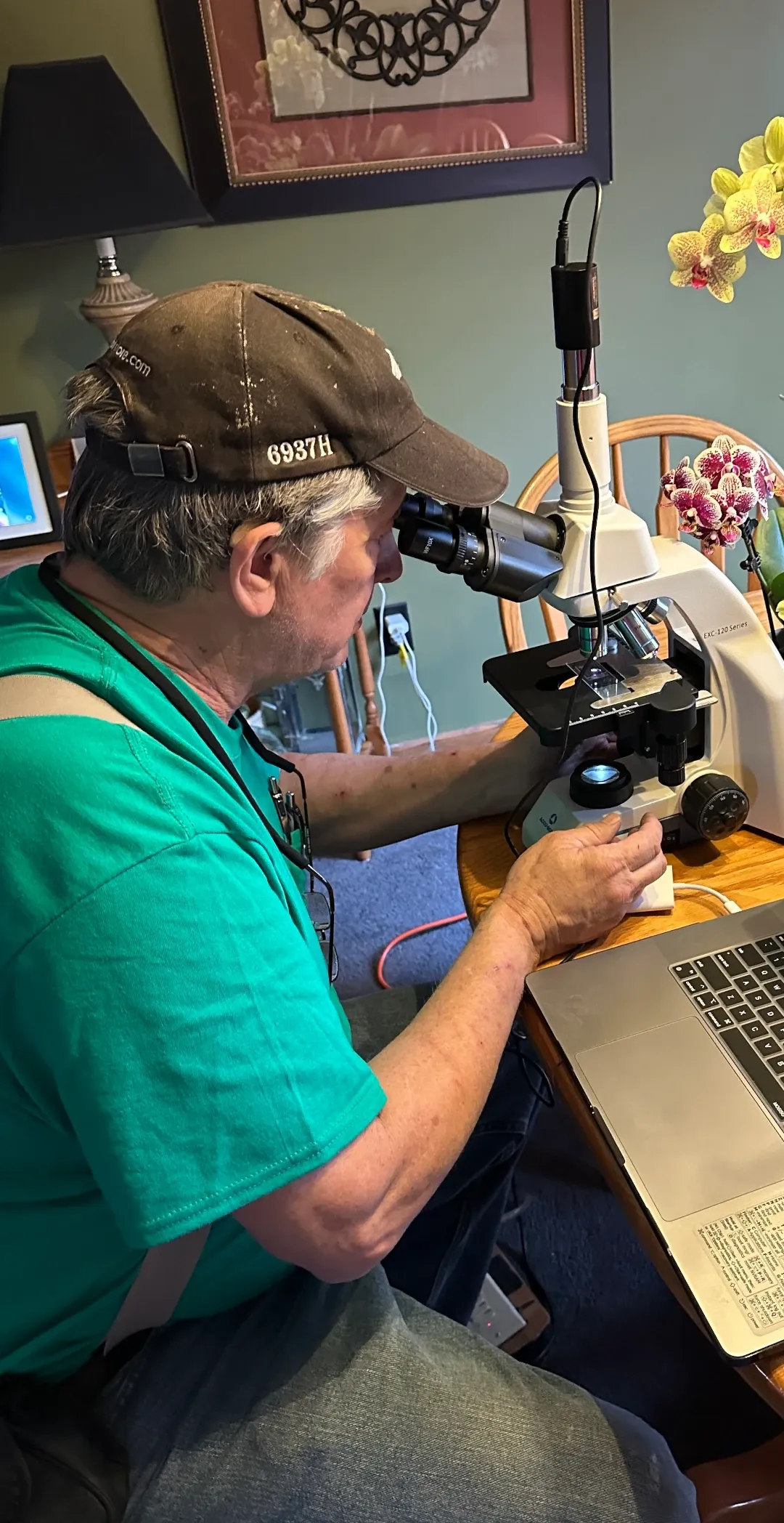 bob looking at sample in microscope