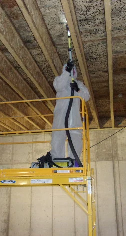 worker on scaffolding in ceiling beams