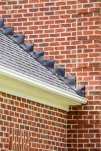 Black flashing covering the intersection of a chimney
