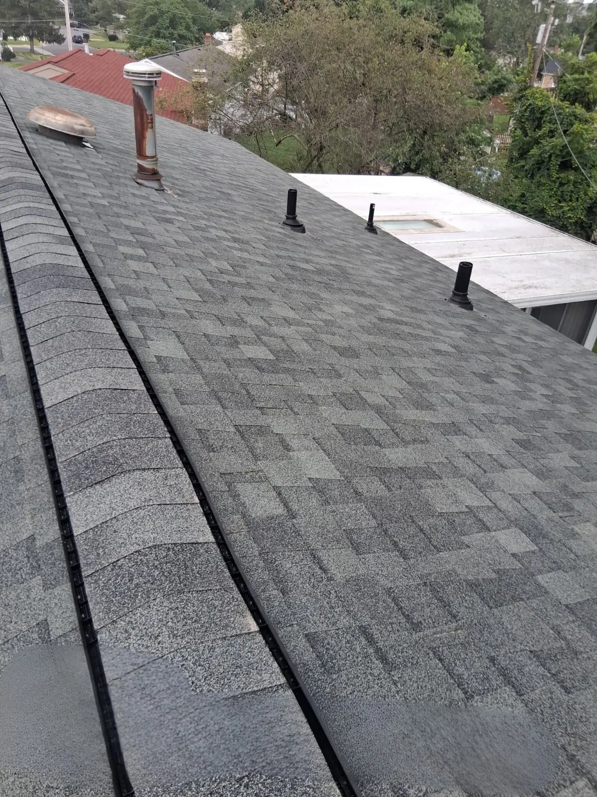 Ridge vent installation underway with new TAMKO Titan XT Shadow Grey shingles in Harrisonburg VA.