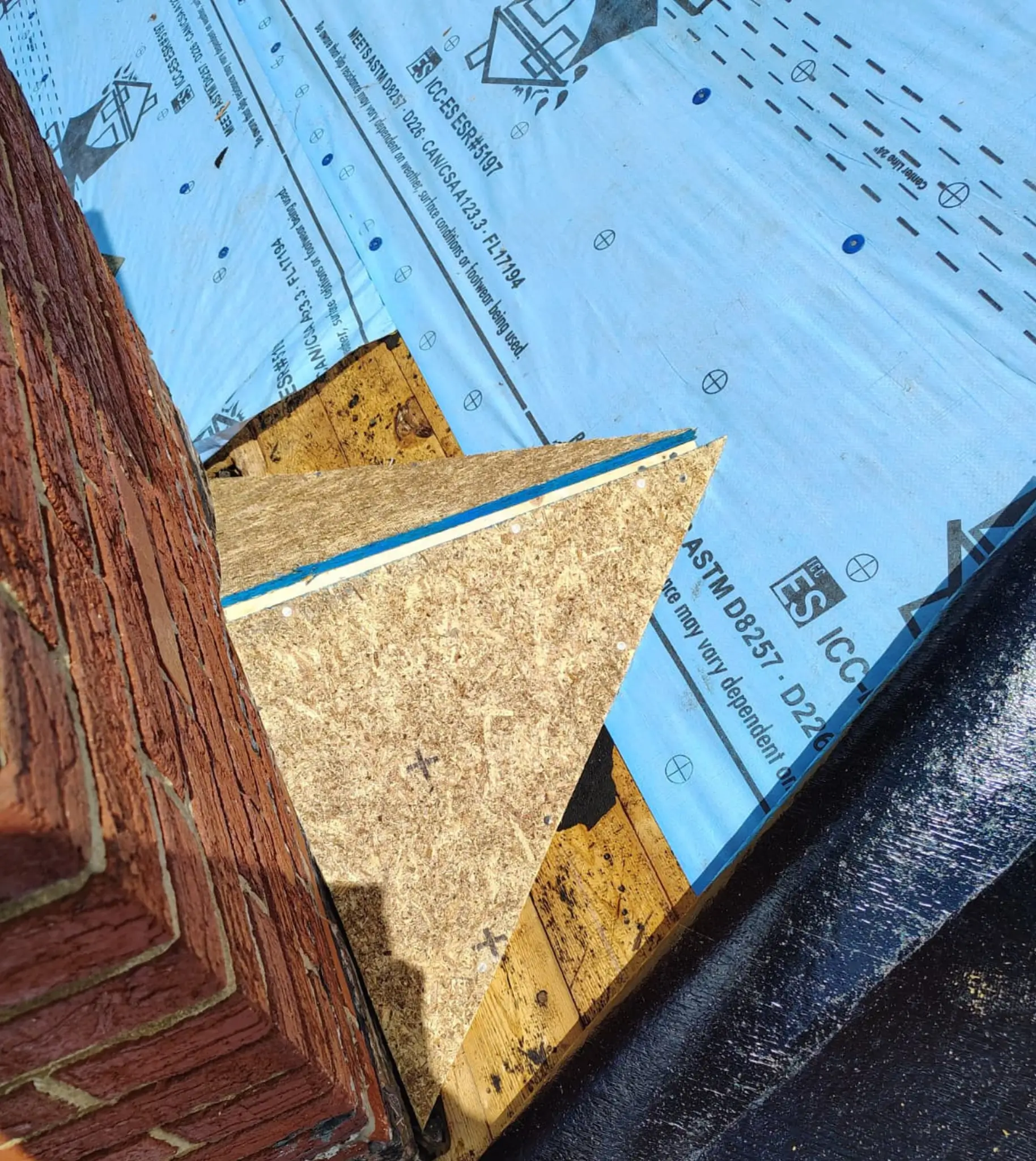 Chimney cricket installed during a roof replacement