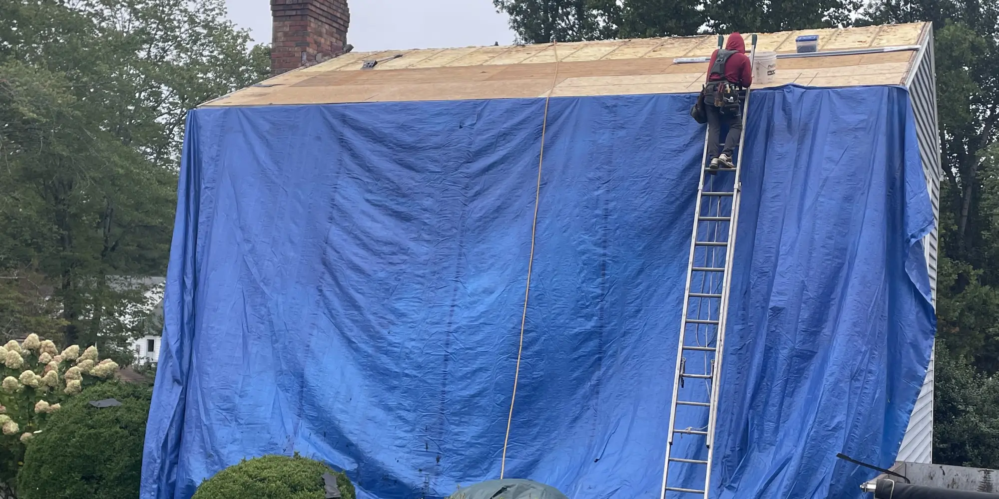 Tarp installed on the house during a roof replacement on Derby Ln in Charlottesville, VA