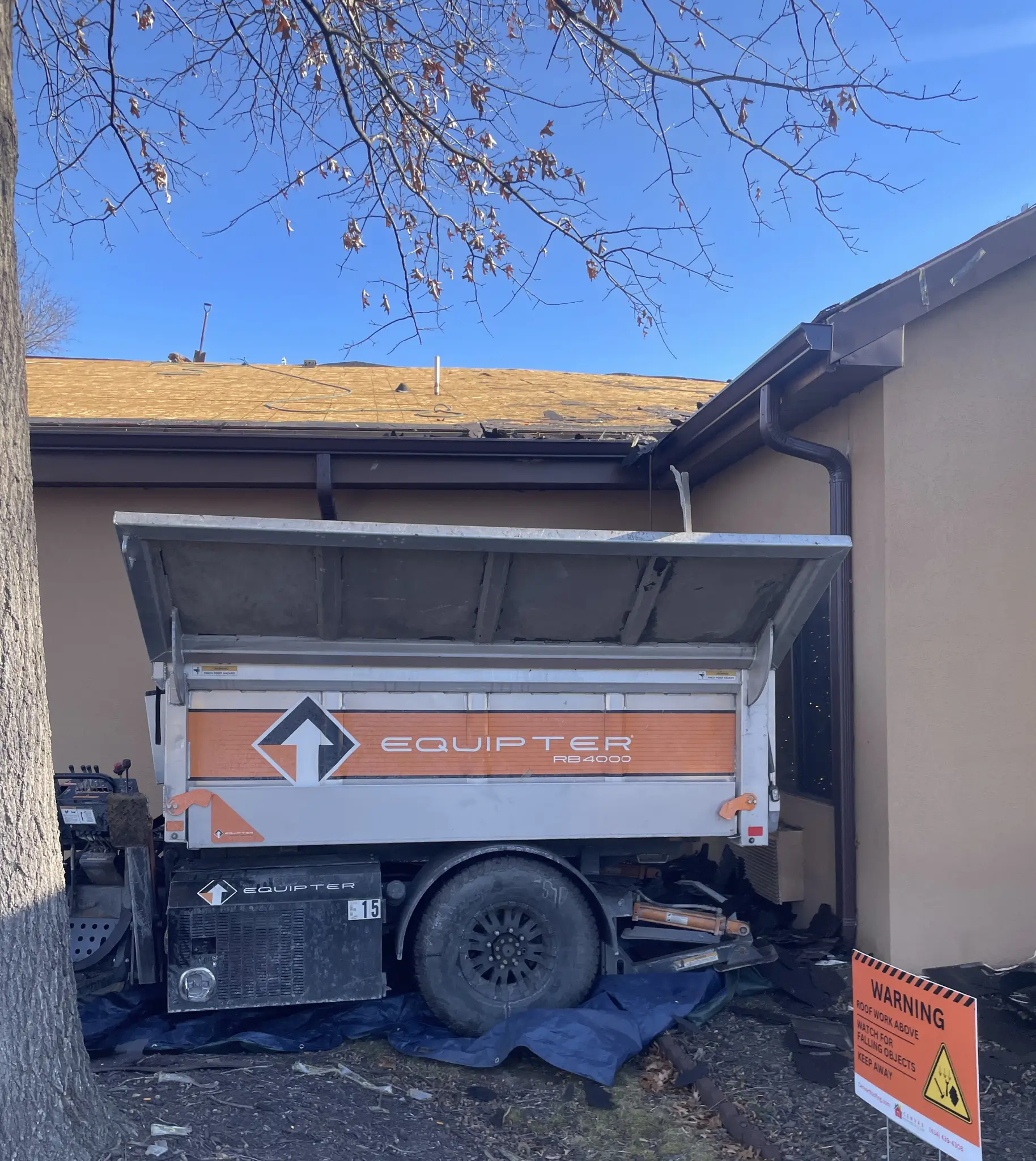 An equipter set up to help with the removal of the old roof on this commercial roof replacement