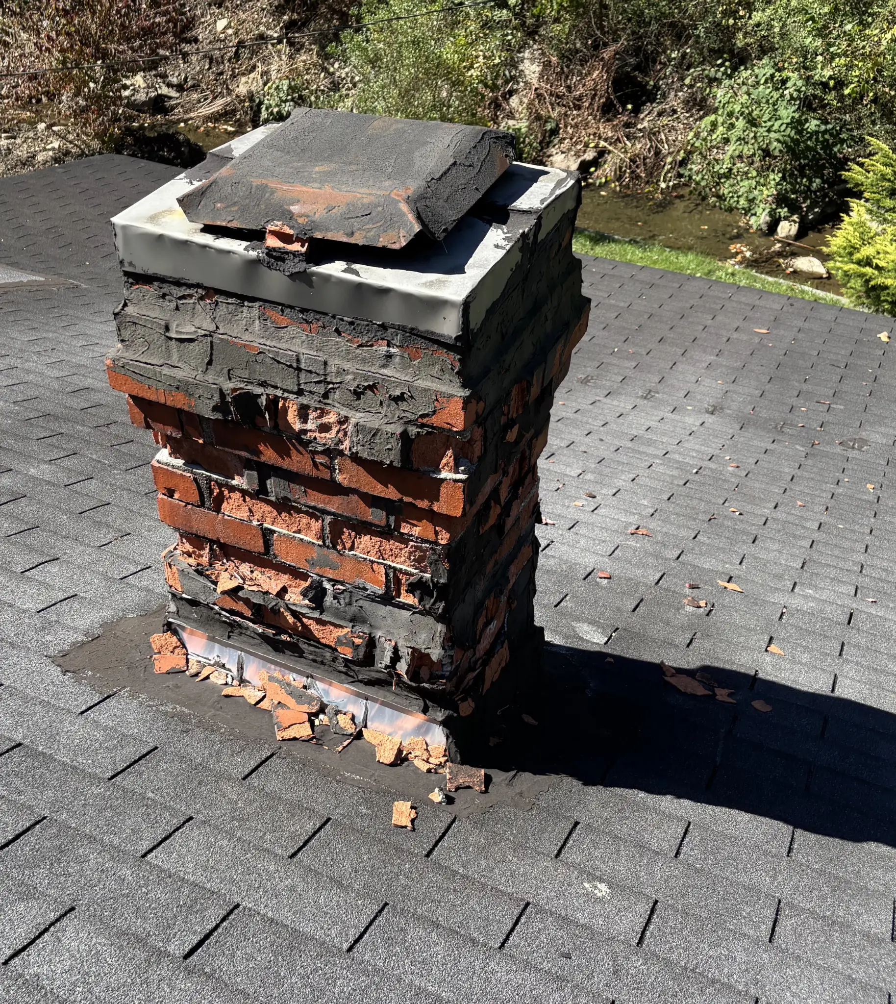 Old chimney in need of new flashing for this roof replacement job