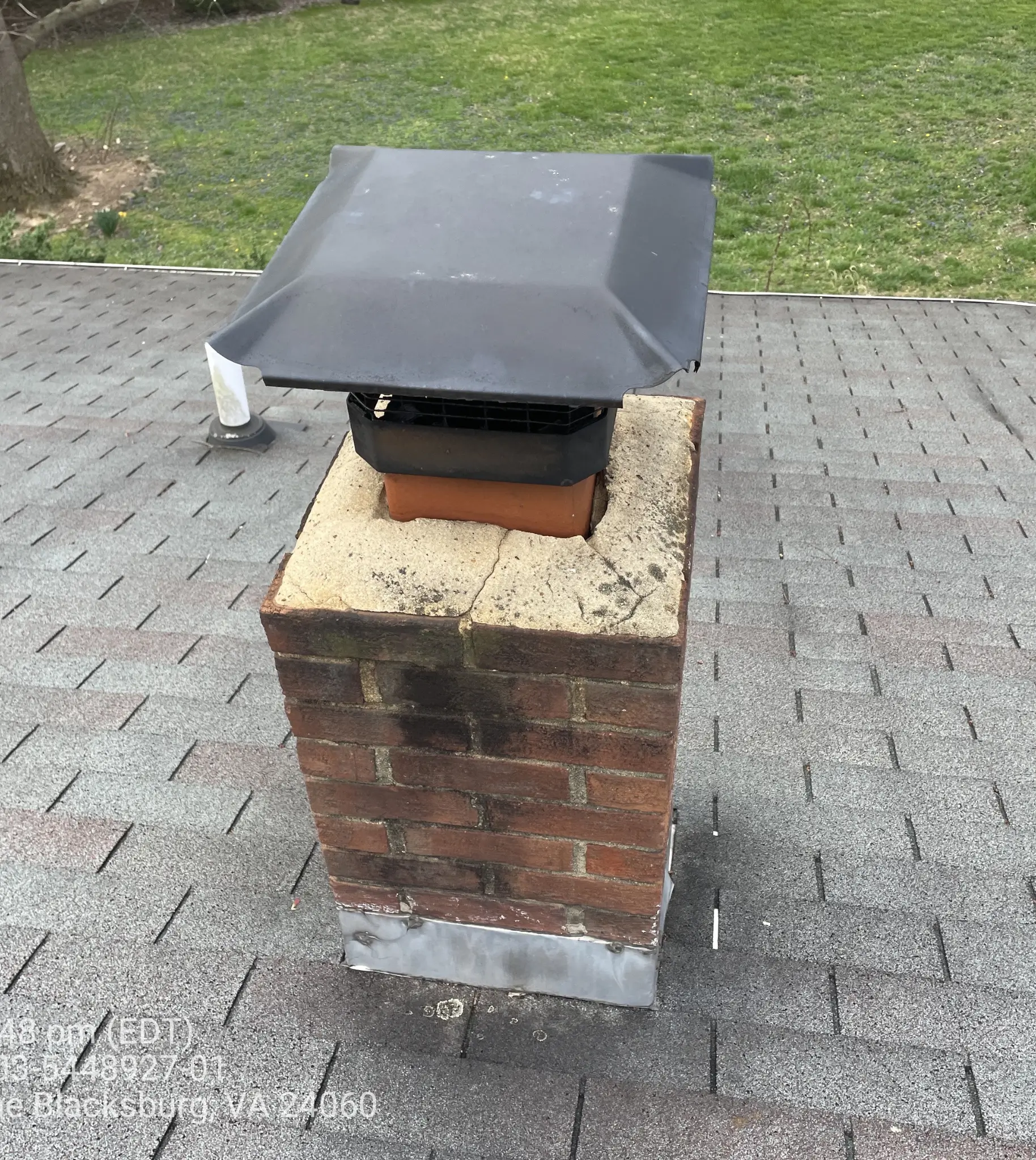 Chimney with flashing and old shingles that need replacing in Blacksburg, VA