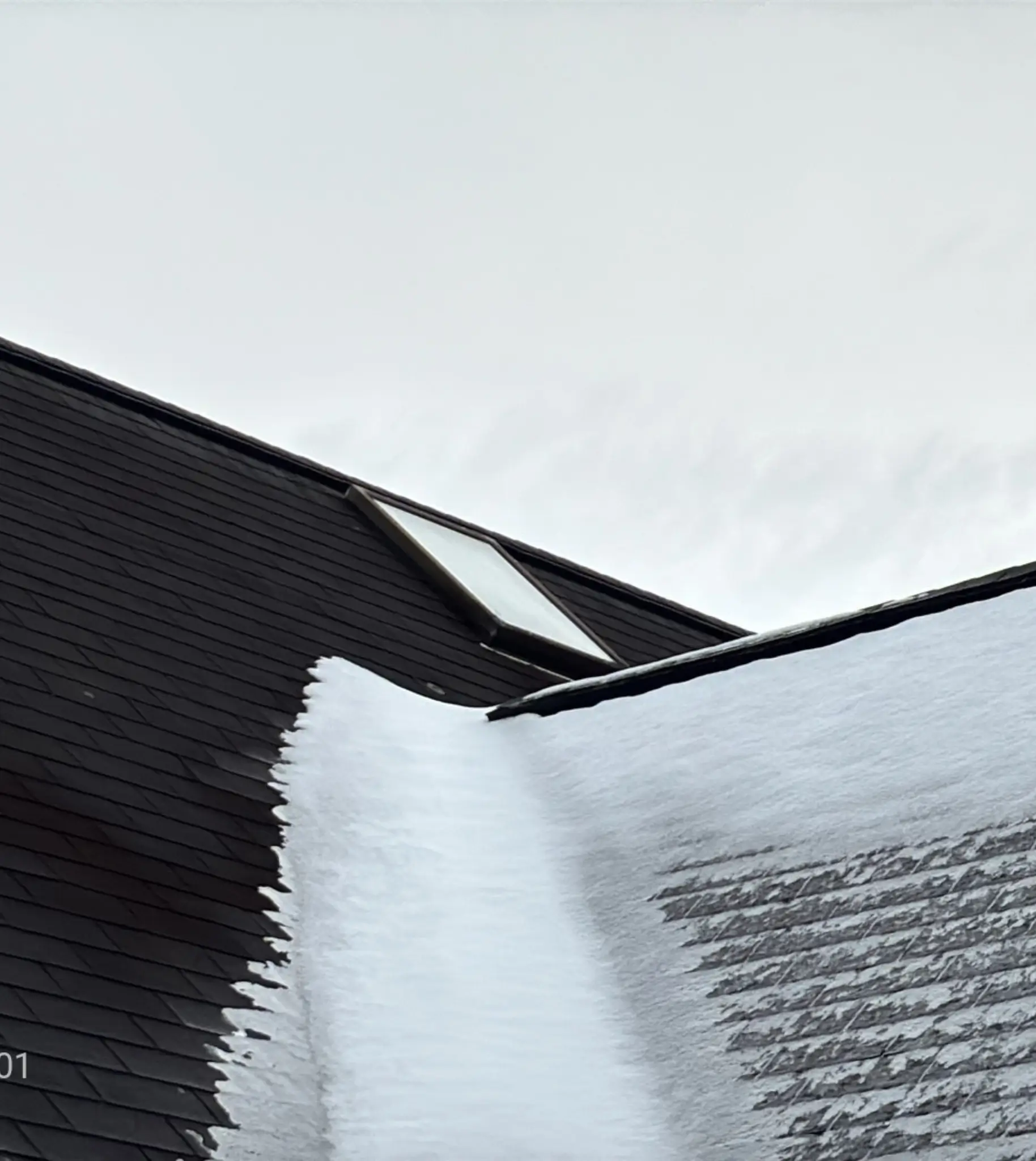 Snow sitting in the valley of this roof during a roof inspection in WV by Cenvar Roofing