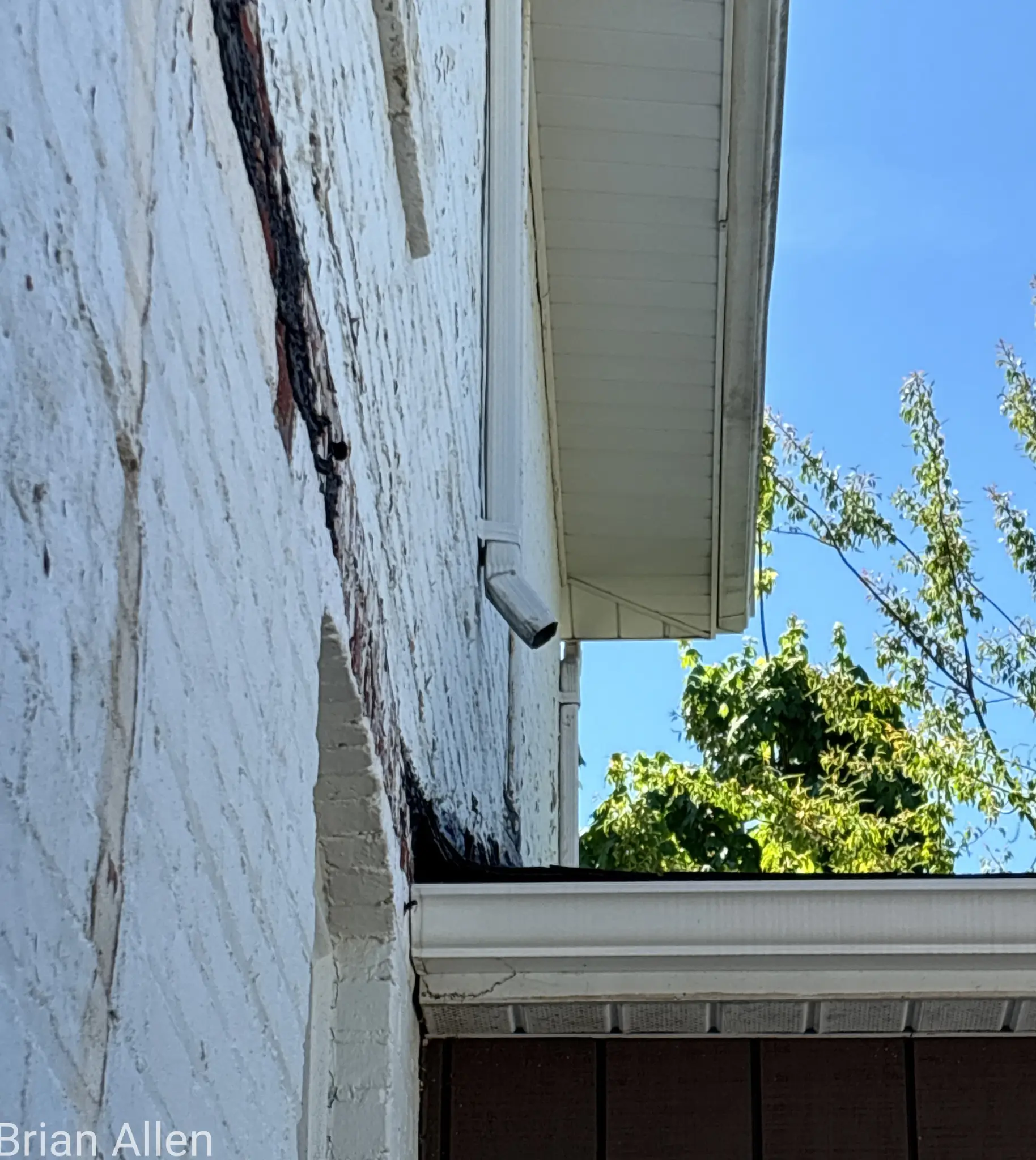 Two-story West Virginia home with detached garage receiving a wind damage shingle roof replacement and chimney removal from the Cenvar Roofing Martinsburg branch