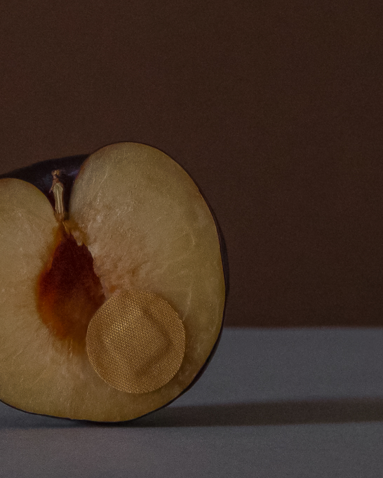 A plum wearing a plaster
