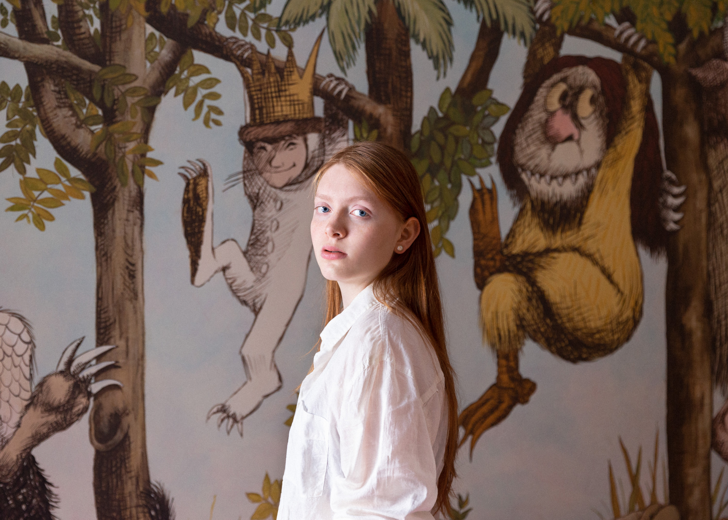 Portrait of Bianca against a mural from 'Where the Wild Things Are.'