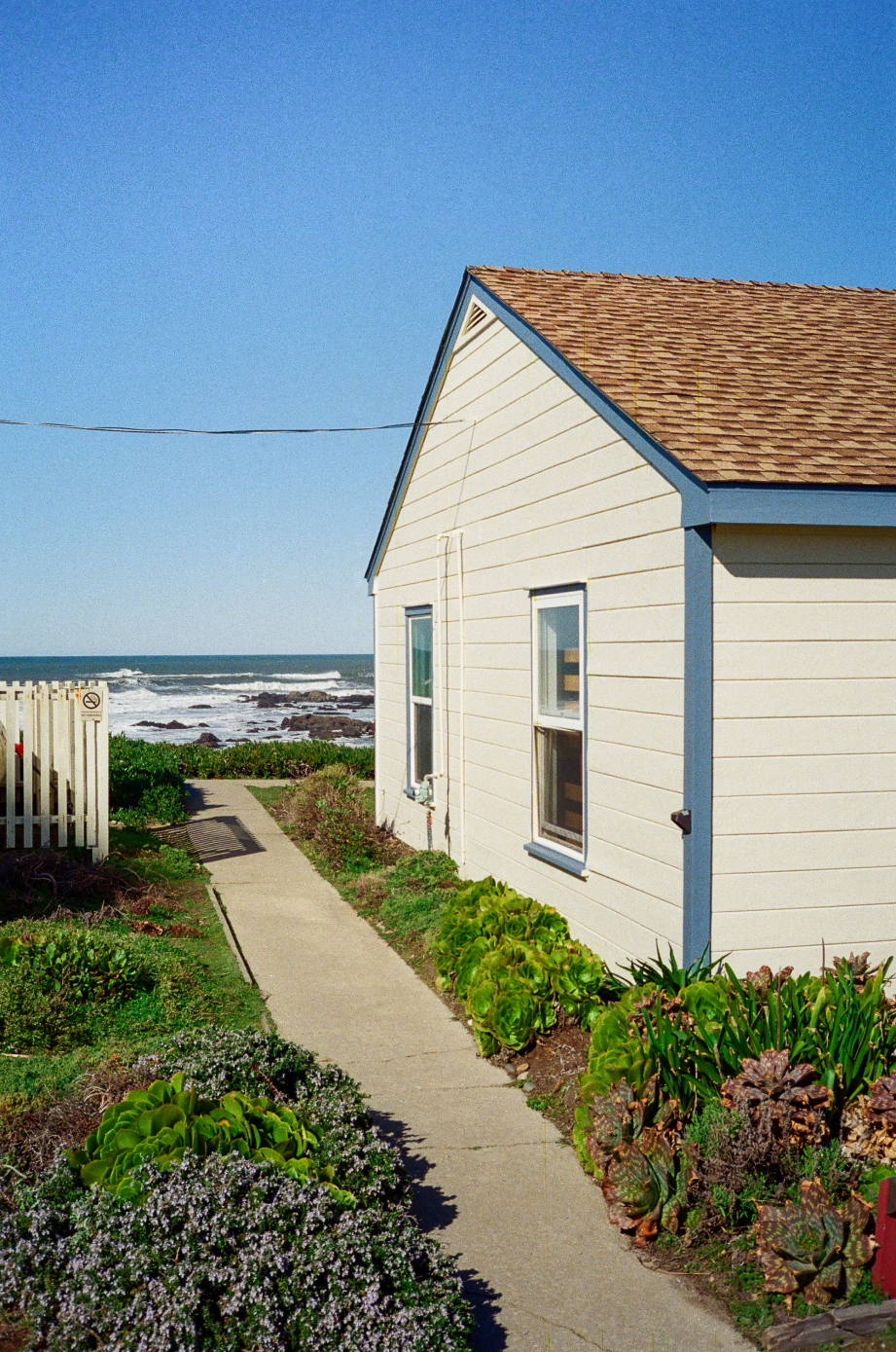 Photo of a house along a boardwalk on the ocean