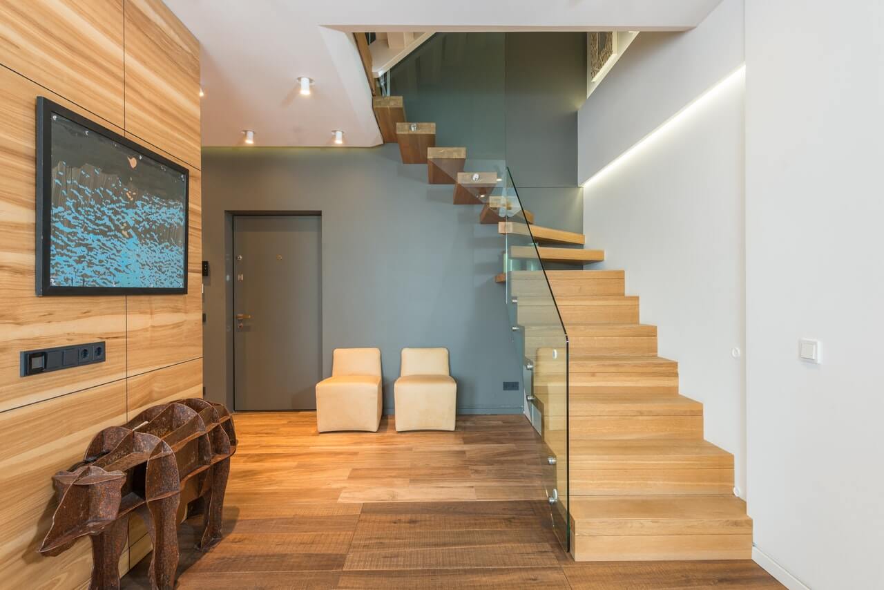 A wooden staircase leading to a living room.