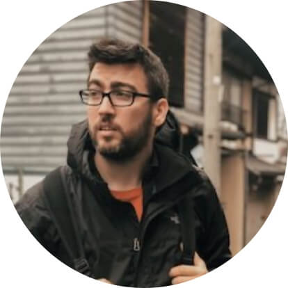 A man wearing glasses and a black jacket.