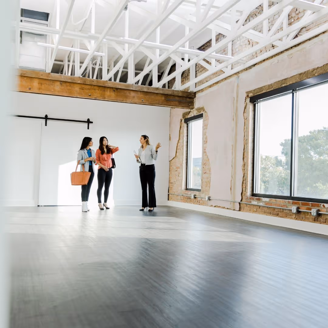 young people touring empty apartment