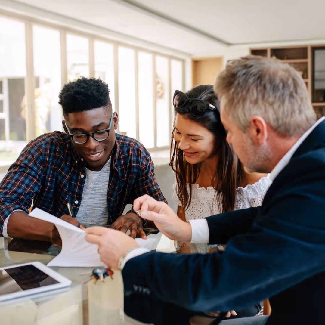 young couple meeting with real estate agent