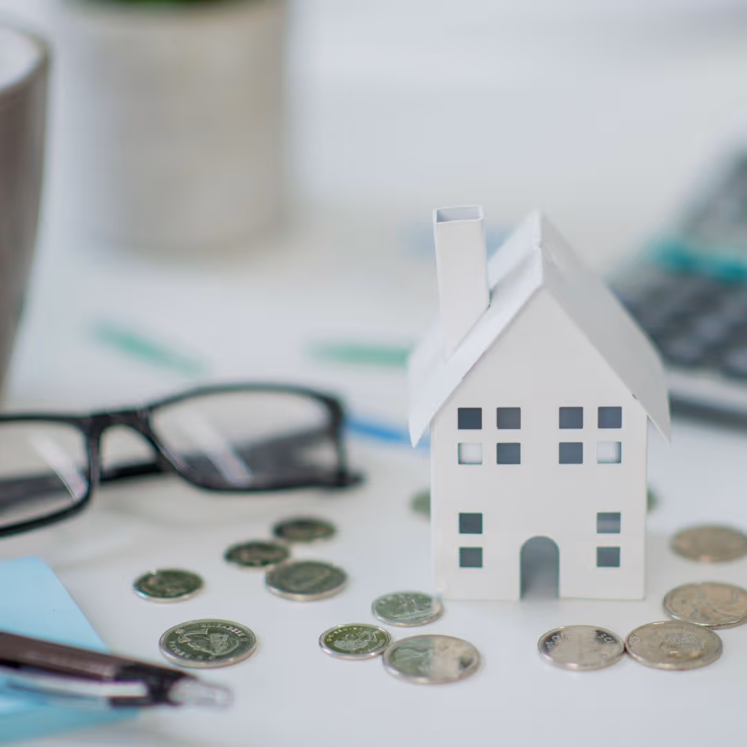 toy house surrounded by coins