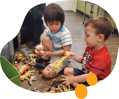 Two children engaging in therapeutic play as part of Pine Cone Prep School