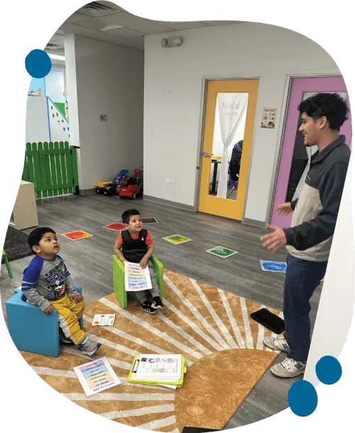 Small group of children playing together with support from RBT at Blossom Prep