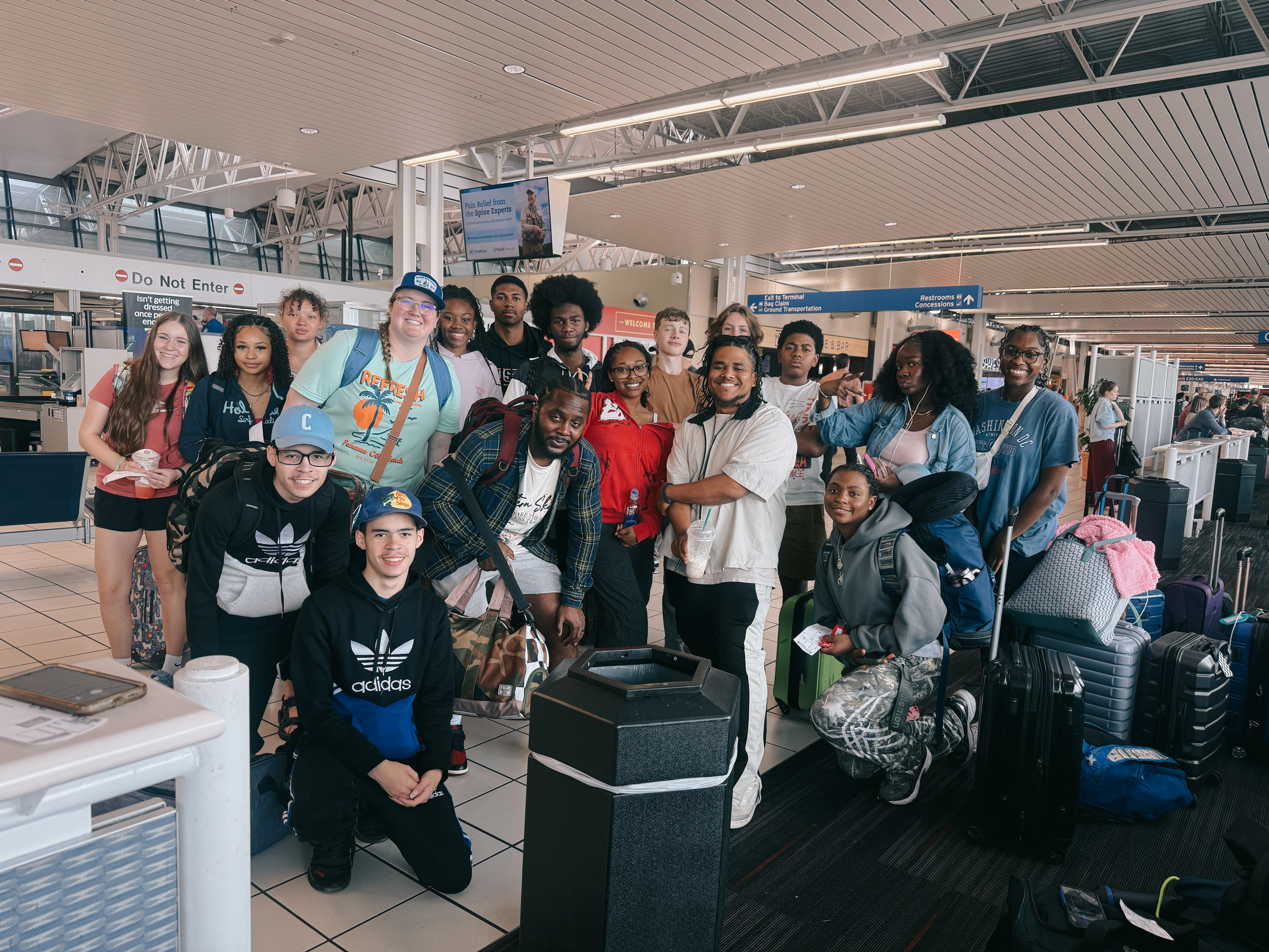 Leaders and high school students in the airport heading to summer camp in Florida.