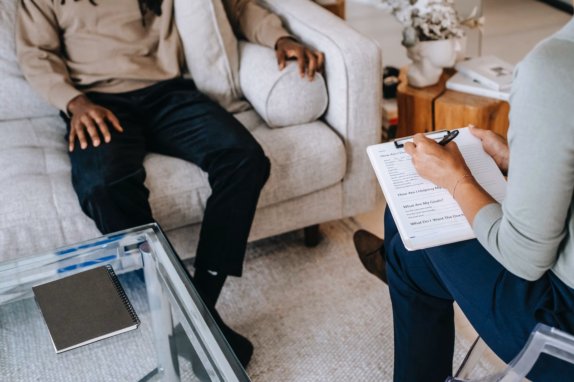 Therapist taking notes with a client