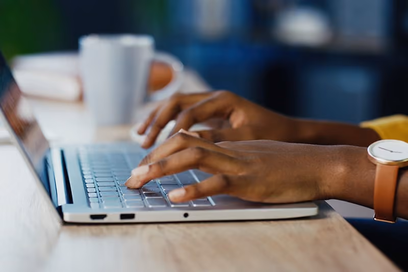 Woman typing on her laptop