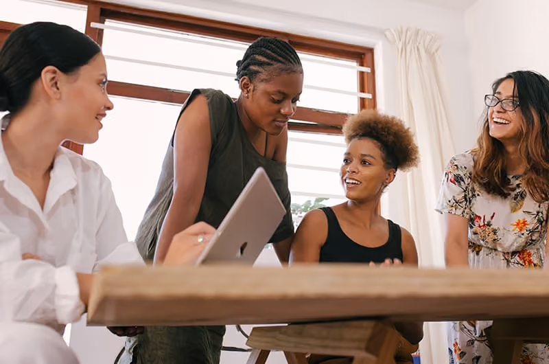 Four women working together in a home office