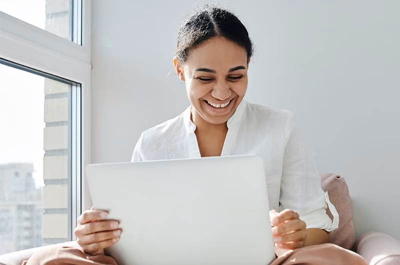 Woman smiling during an online therapy session