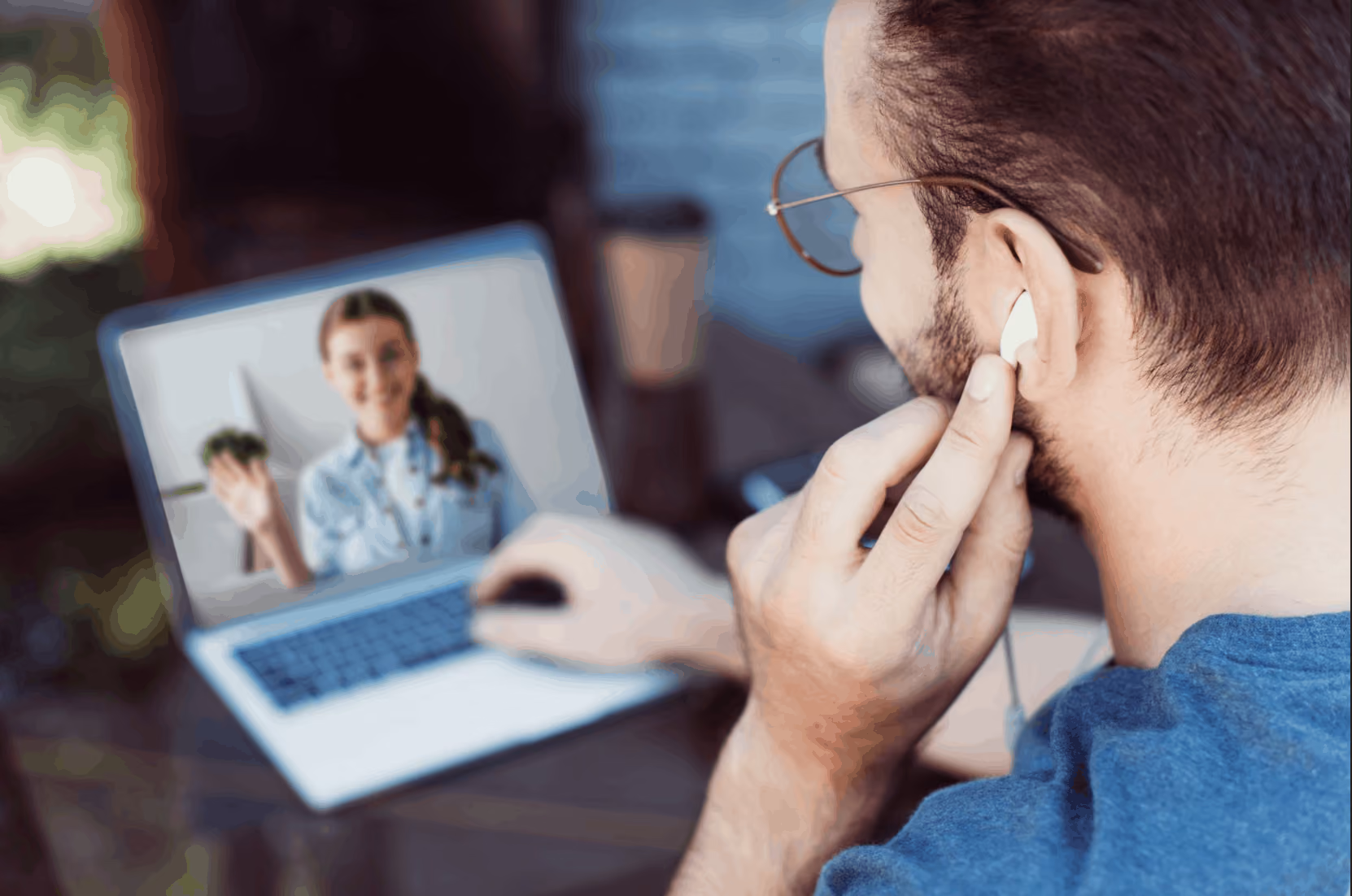 Man on a laptop chatting with a coworker