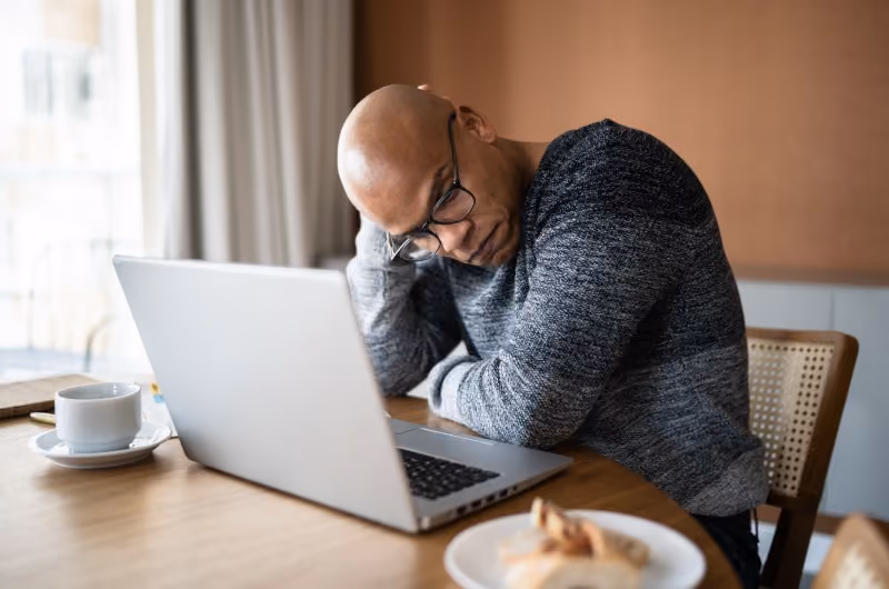 A man experiecing workplace discrimination while working virtually