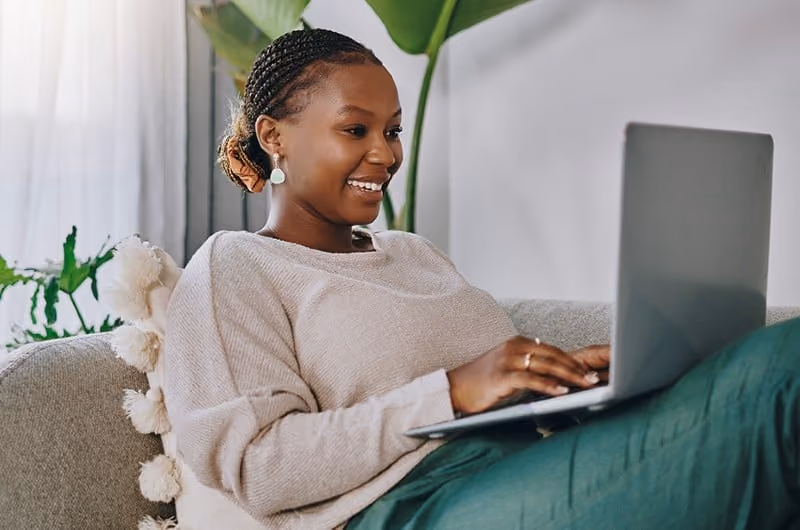Clinician writing a blog post on her laptop