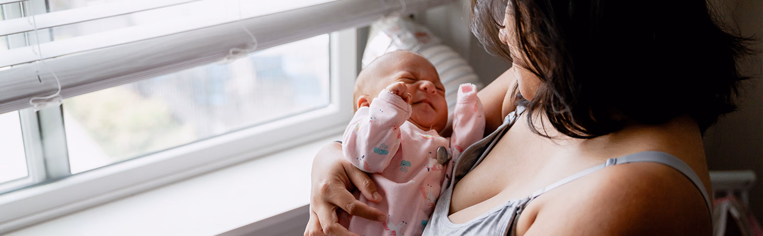 Mother holding her newborn baby in her arms at the hospital
