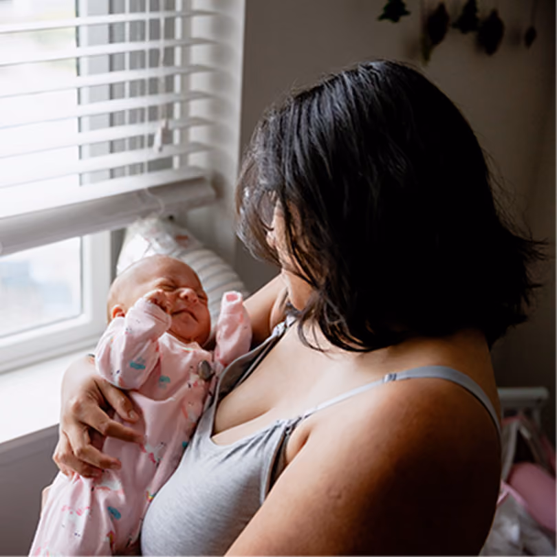 Mother holding her newborn baby in her arms at the hospital