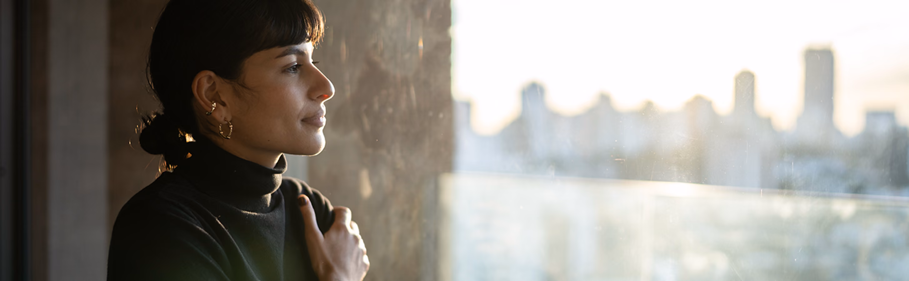 A dark-haired business woman is experiencing the benefits of a mindfulness practice at work