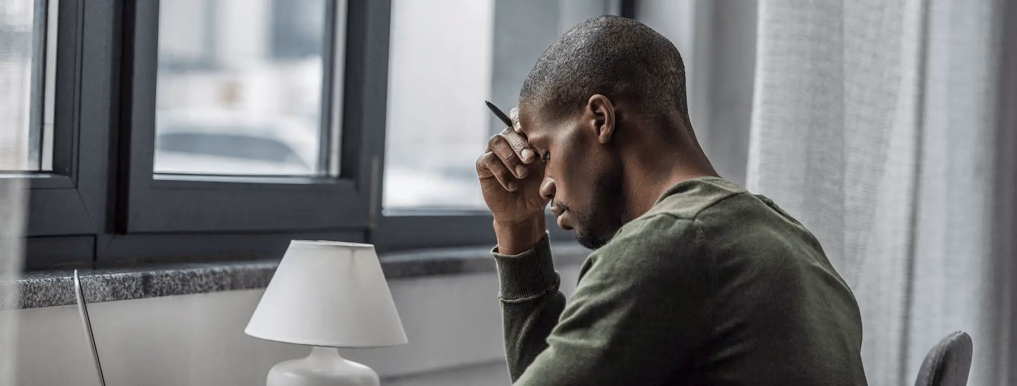 Black man with a pen in his hand working