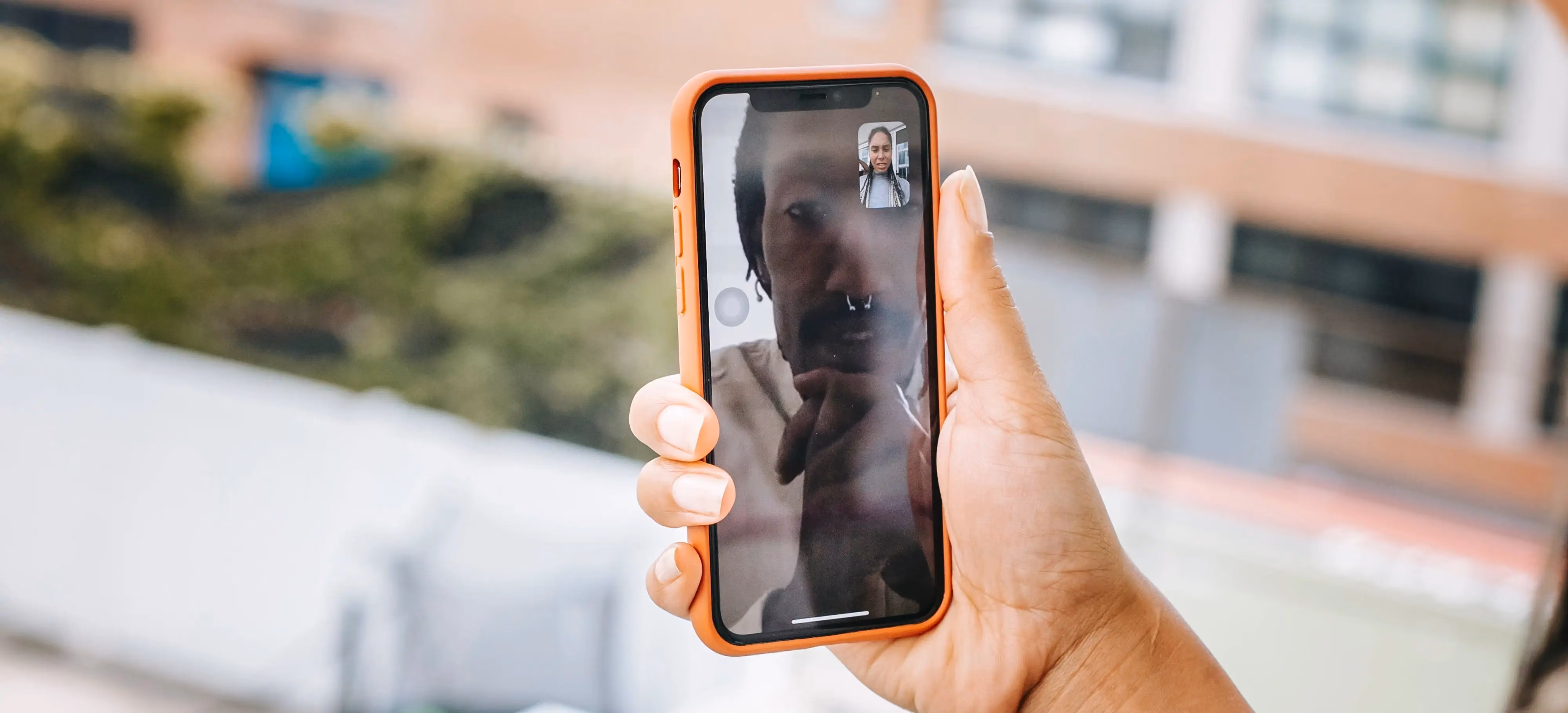 Woman taking an online teletherapy call from her balcony