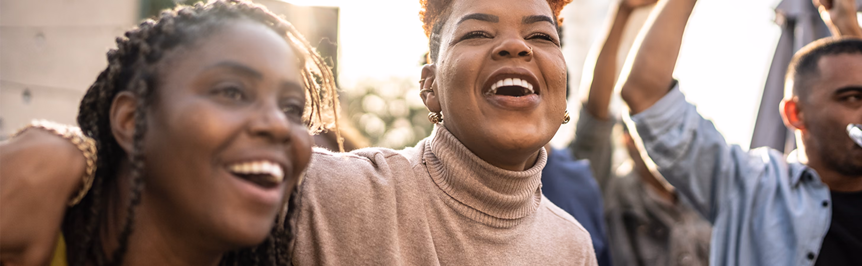 Women of color full of joy walking in the street together