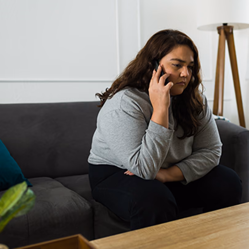 woman sitting on the phone after layoff