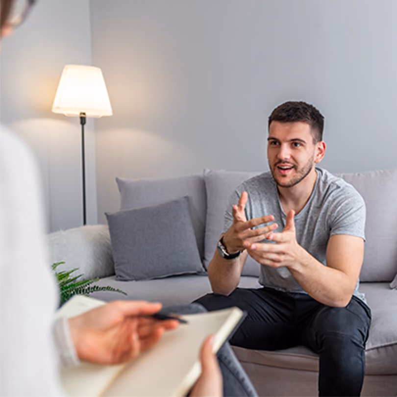 Man having a conversation with his therapist in-person