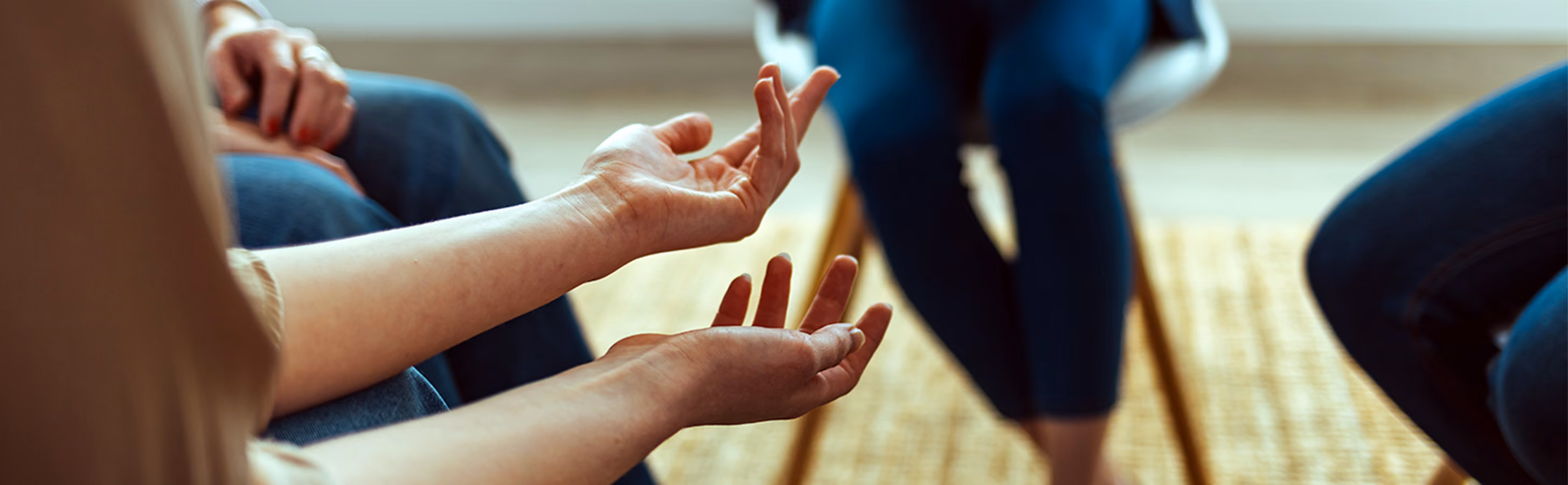 A close up photo of hands of a patient in group therapy