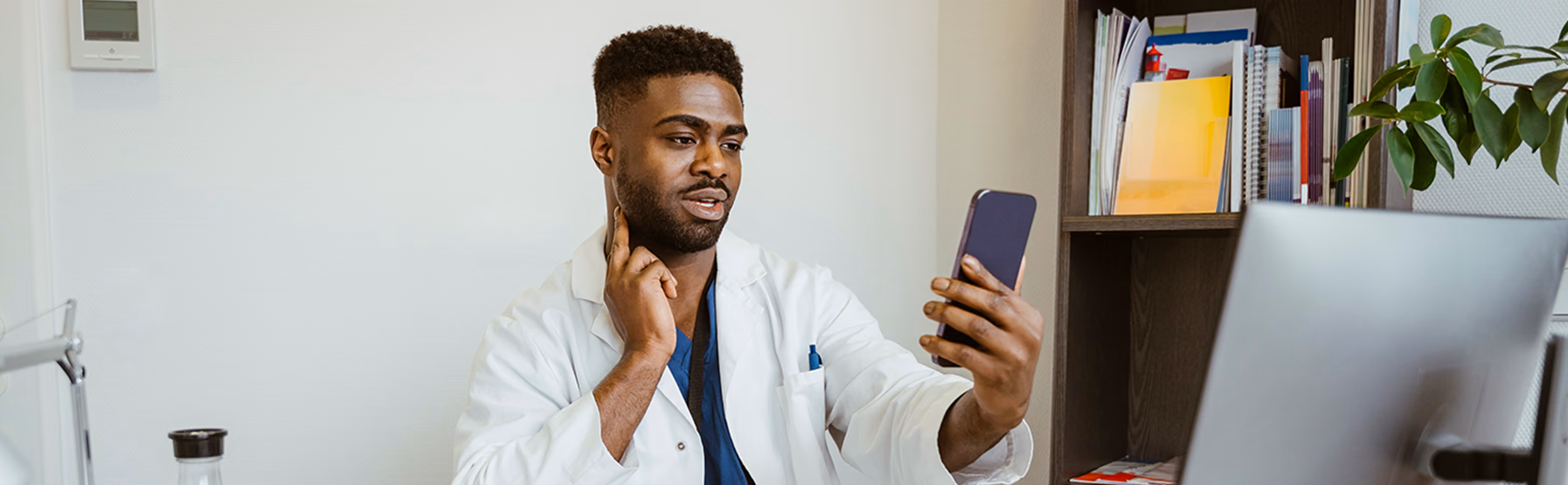Doctor showing a telehealth patient how to check vitals