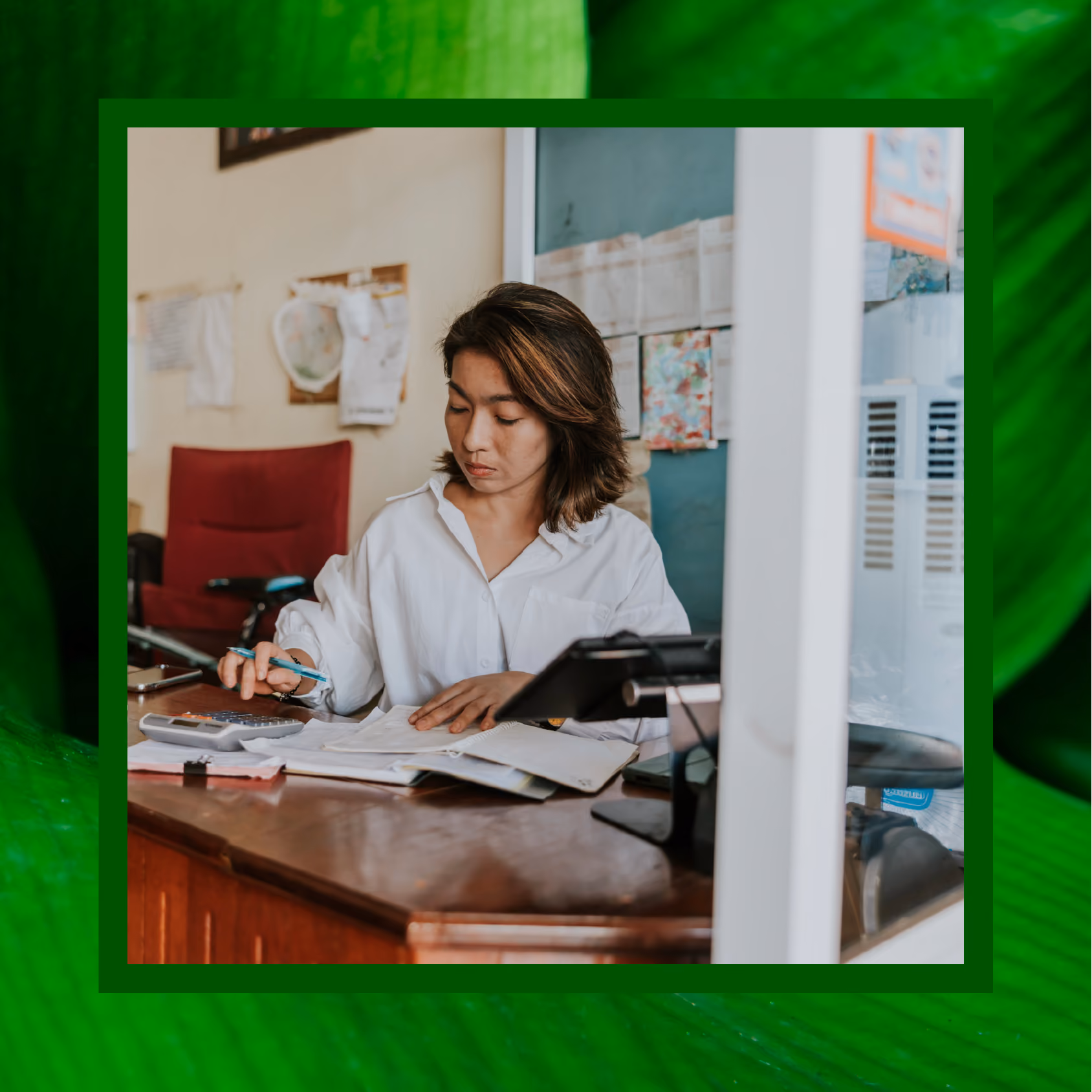 Woman using a calculator for work at her desk