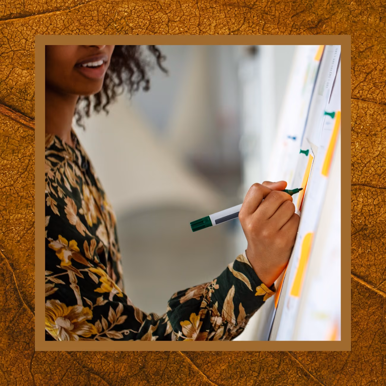 A woman writing notes on a whiteboard