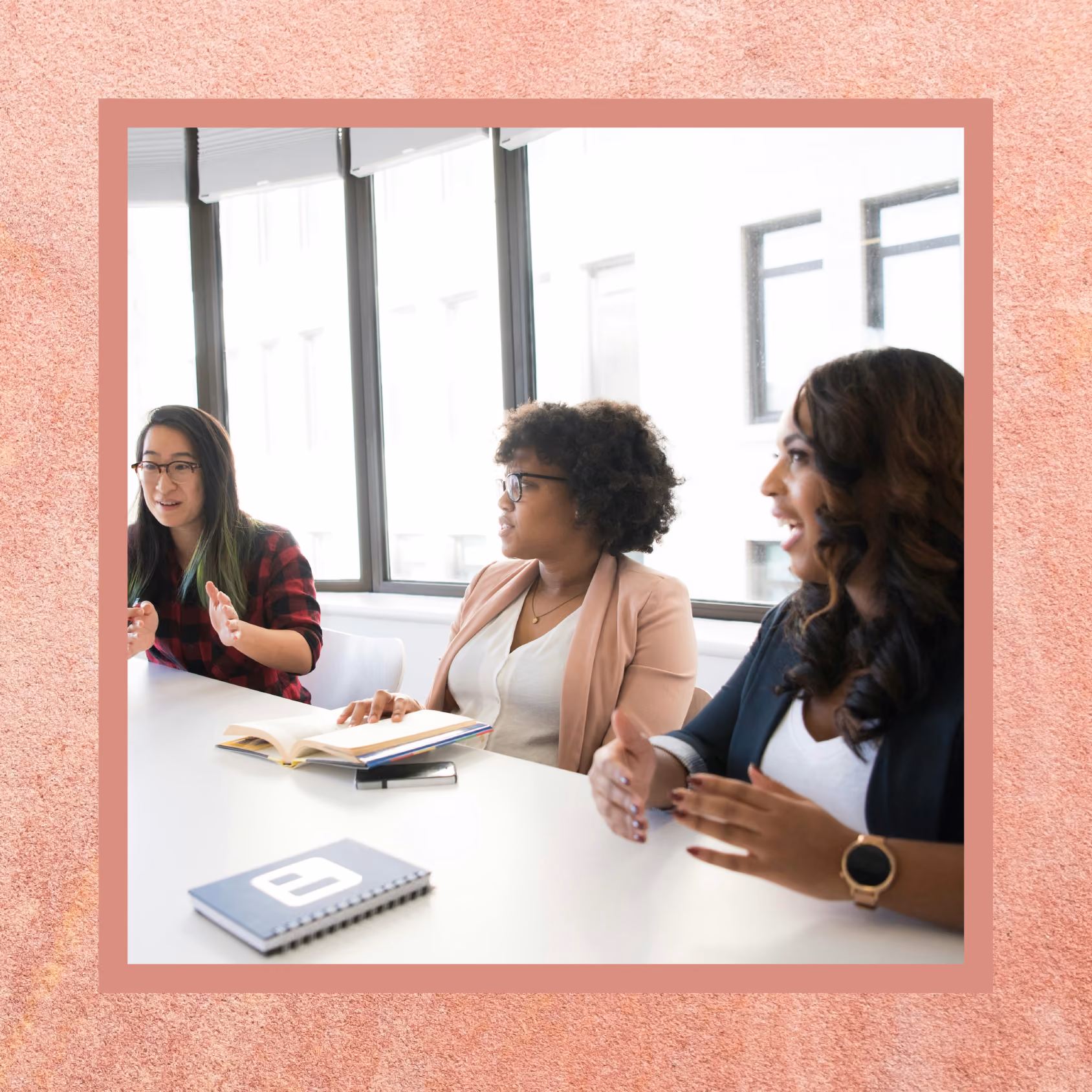 Three women discussing a business project in a meeting