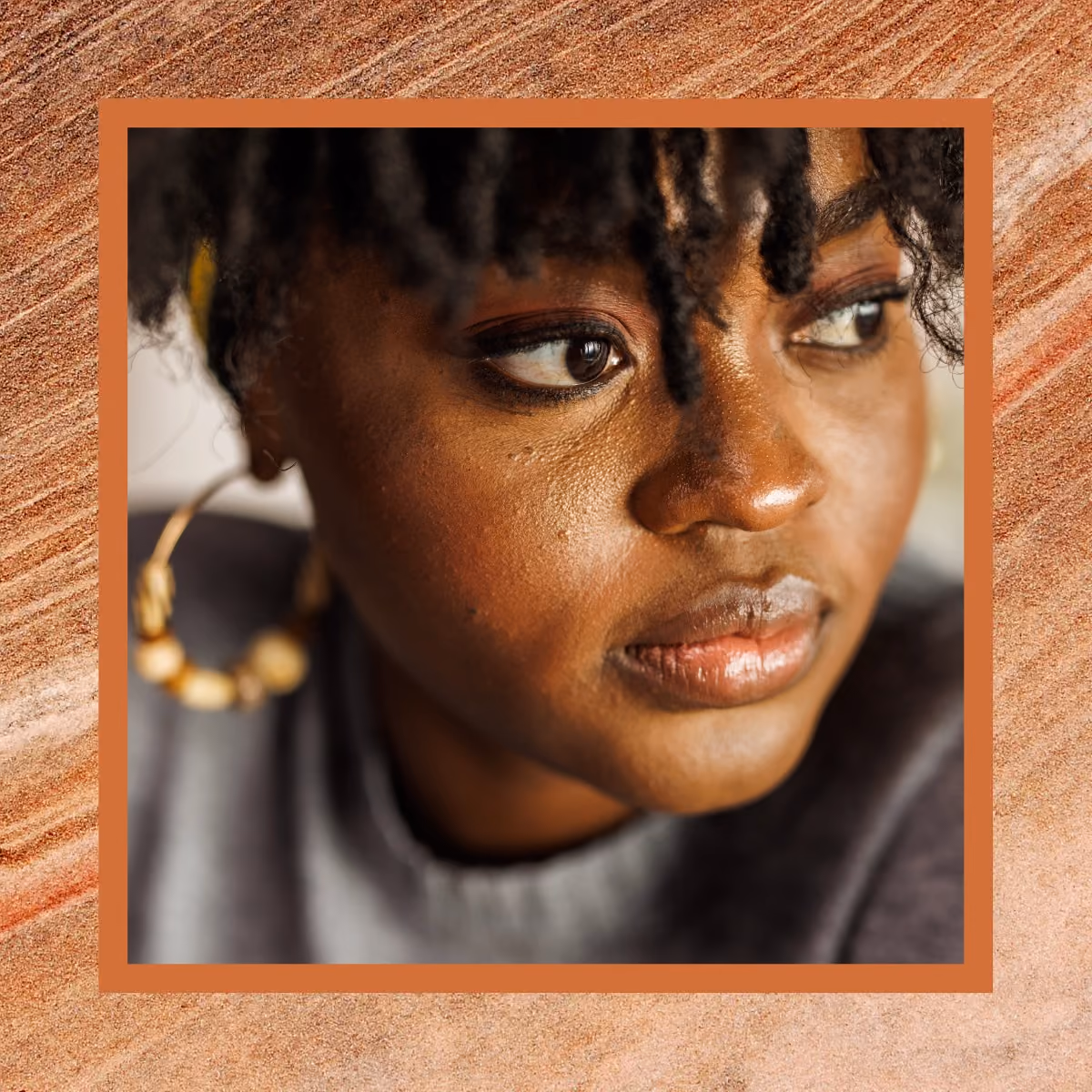 A black woman stares intently to the side