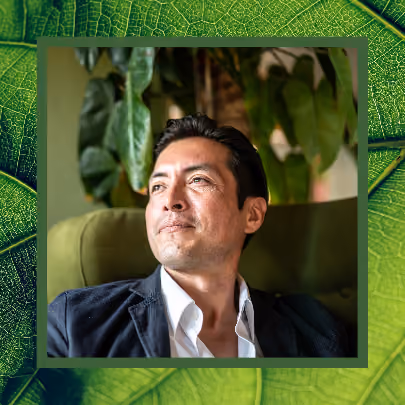 A man in a suit smiles contently
